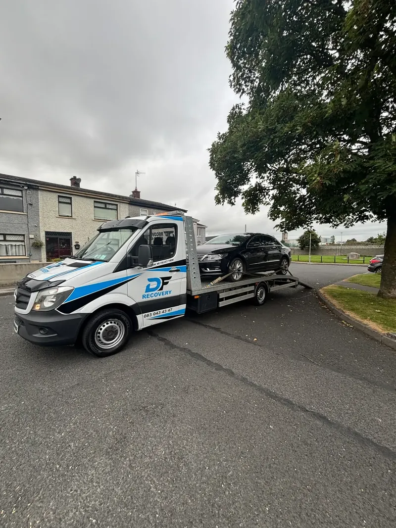 DF Recovery flatbed collecting a black Volkswagen on a residential street in Louth