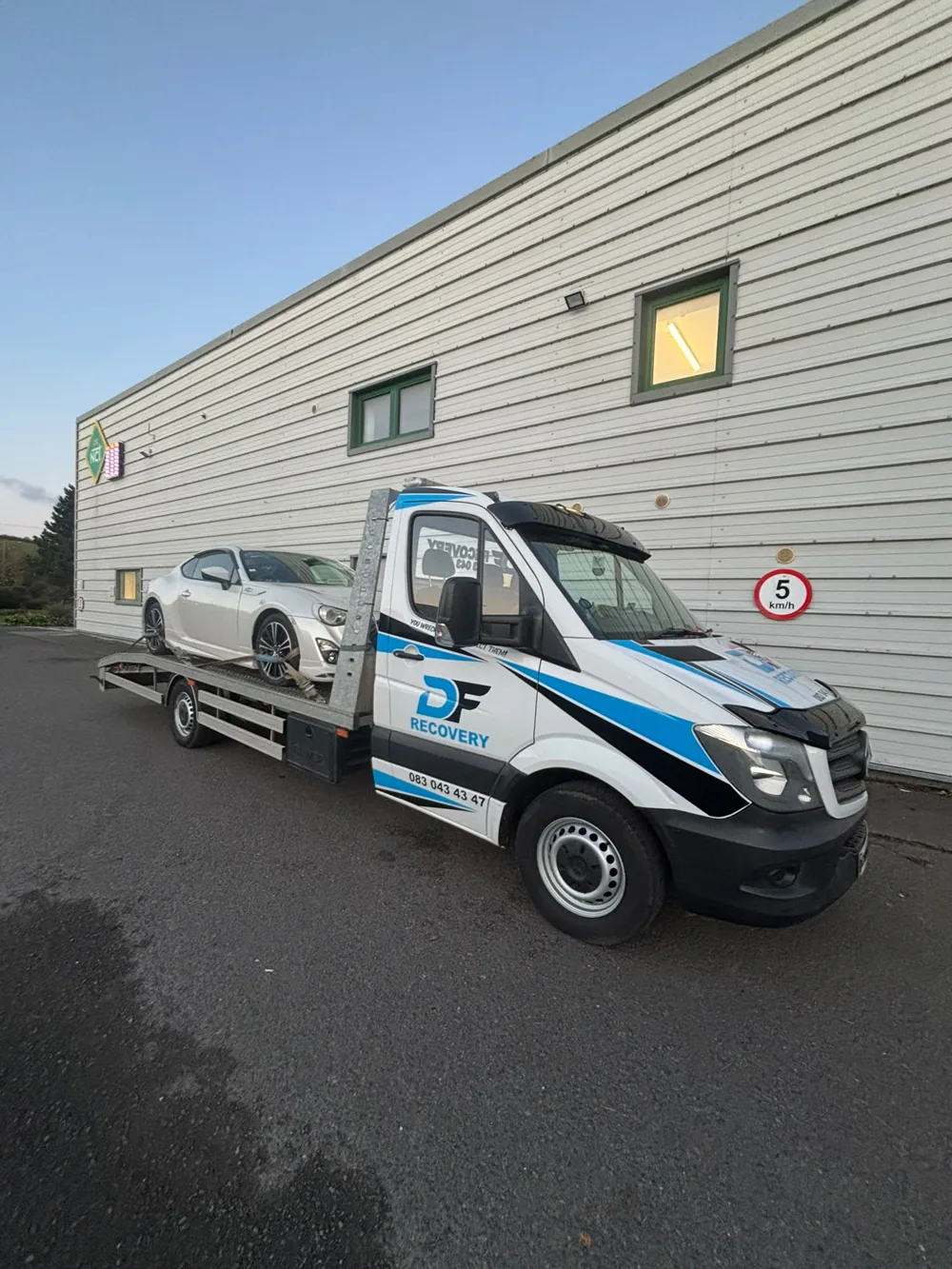 Vehicle collection with DF Recovery's branded Mercedes flatbed